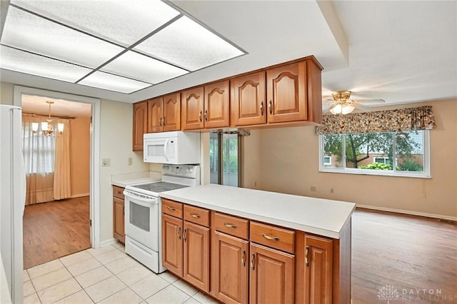 2184 Broadbent Way, Dayton, OH 45440 - kitchen featuring white appliances, brown cabinets, a peninsula, and a chandelier
