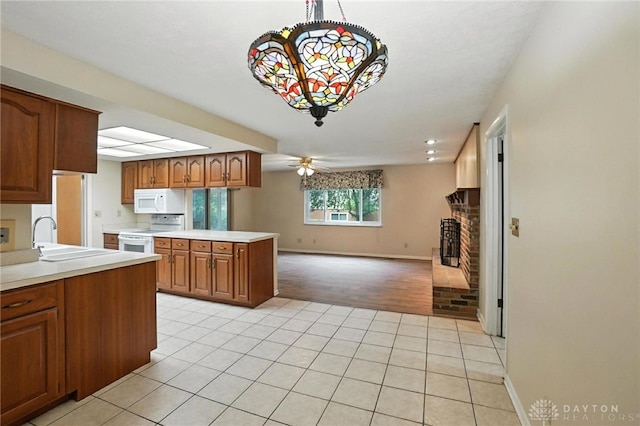 2184 Broadbent Way, Dayton, OH 45440 - kitchen with light tile patterned flooring, white appliances, open floor plan, and light countertops