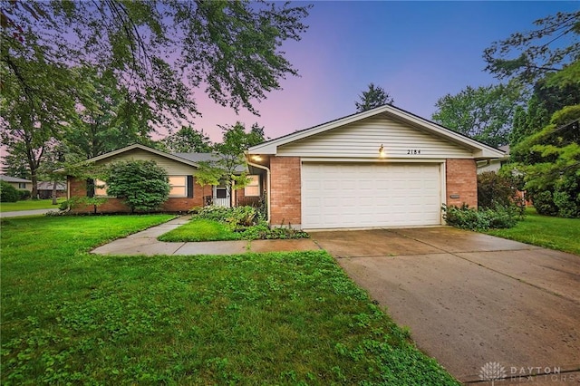 2184 Broadbent Way, Dayton, OH 45440 - ranch-style home with brick siding, a lawn, concrete driveway, and a garage