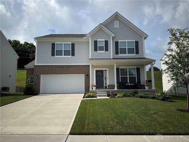 11916 Abbeytown Dr, Colerain Twp, OH 45251 - view of front facade with driveway, a porch, an attached garage, and a front lawn