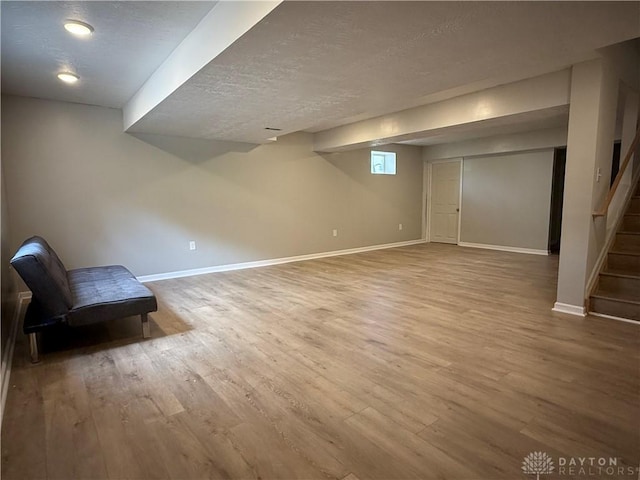 11916 Abbeytown Dr, Colerain Twp, OH 45251 - below grade area with wood finished floors, a textured ceiling, and stairway