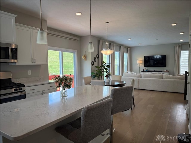 11916 Abbeytown Dr, Colerain Twp, OH 45251 - kitchen featuring stainless steel appliances, healthy amount of natural light, light wood-style floors, recessed lighting, and white cabinets