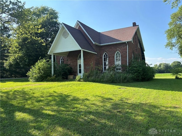 6008 Delisle-Fourman Rd, Arcanum, OH 45304 - view of front of property with brick siding, a chimney, and a front yard