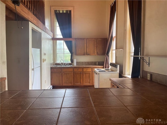 6008 Delisle-Fourman Rd, Arcanum, OH 45304 - kitchen featuring white appliances, tile countertops, and brown cabinetry