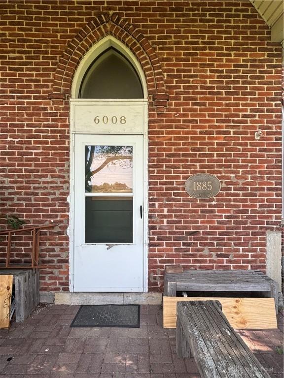 6008 Delisle-Fourman Rd, Arcanum, OH 45304 - property entrance with brick siding