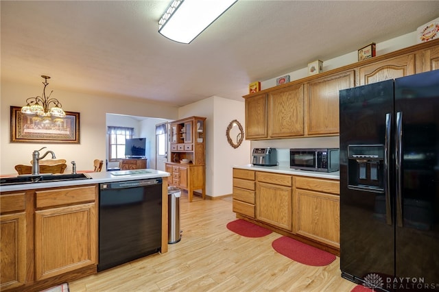 215 Christina Way, Franklin, OH 45005 - kitchen featuring black appliances, light countertops, light wood finished floors, and brown cabinetry