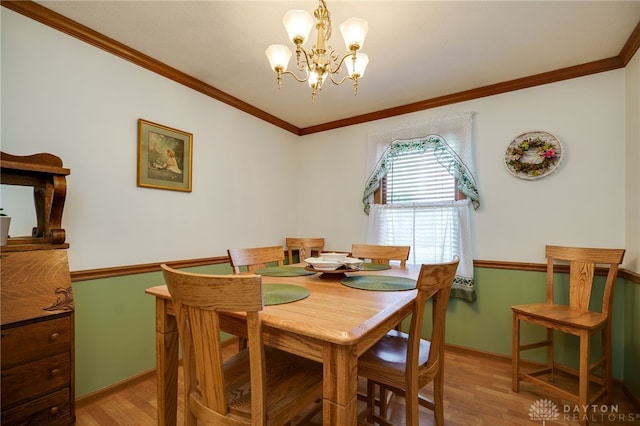 215 Christina Way, Franklin, OH 45005 - dining area with light wood finished floors, a chandelier, and crown molding