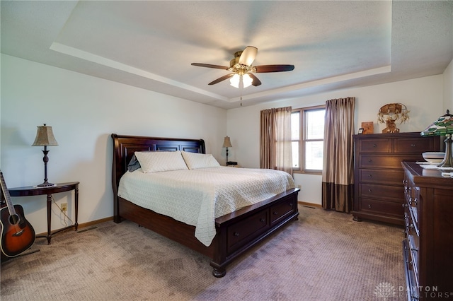 215 Christina Way, Franklin, OH 45005 - bedroom with a tray ceiling, light colored carpet, and a ceiling fan