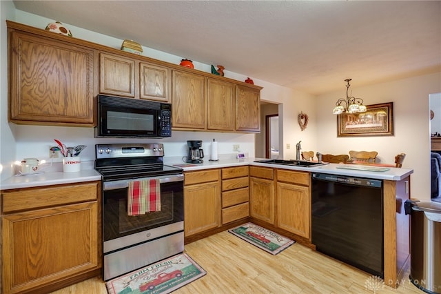 215 Christina Way, Franklin, OH 45005 - kitchen featuring black appliances, light wood finished floors, a peninsula, and light countertops