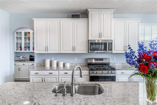 9282 Maple Brook St, Clearcreek Twp, OH 45458 - kitchen featuring stainless steel appliances, white cabinetry, and light stone countertops