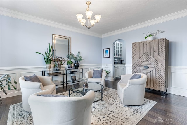 9282 Maple Brook St, Clearcreek Twp, OH 45458 - living area featuring a chandelier, wood finished floors, wainscoting, ornamental molding, and a decorative wall