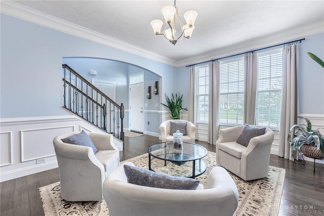 9282 Maple Brook St, Clearcreek Twp, OH 45458 - living room featuring a chandelier, arched walkways, stairs, wood finished floors, and wainscoting