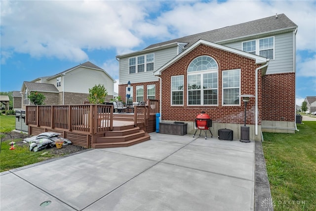 9282 Maple Brook St, Clearcreek Twp, OH 45458 - rear view of property featuring brick siding, a deck, and a patio area