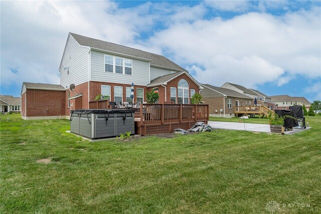 9282 Maple Brook St, Clearcreek Twp, OH 45458 - back of house with a hot tub, brick siding, a wooden deck, and a yard