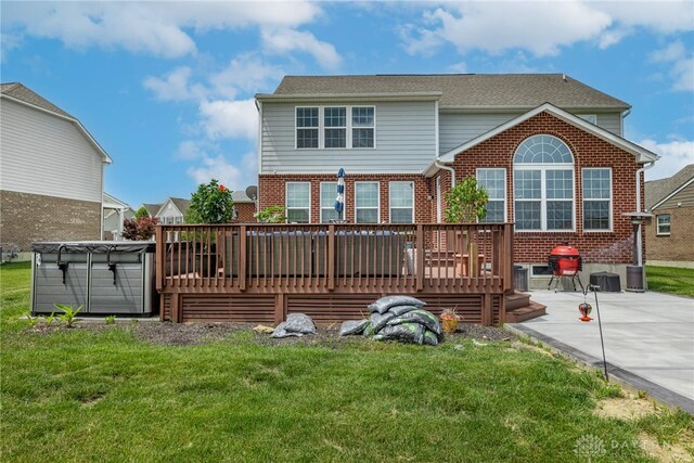 9282 Maple Brook St, Clearcreek Twp, OH 45458 - back of property with brick siding, a deck, a patio area, and a lawn