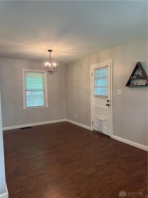 5001 Central Ave, Middletown, OH 45044 - unfurnished room with dark wood-style floors and a chandelier