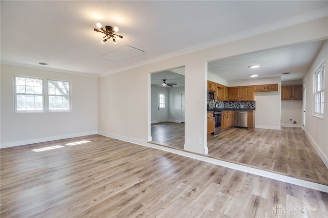 3183 Myers Tillman Rd, Arcanum, OH 45304 - unfurnished living room featuring light wood-style floors, crown molding, and attic access