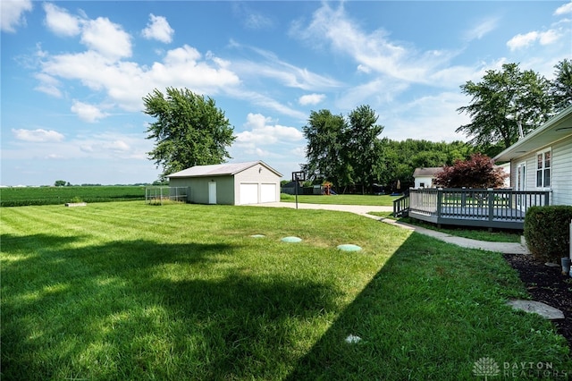3183 Myers Tillman Rd, Arcanum, OH 45304 - view of green lawn featuring a garage, a deck, an outdoor structure, and driveway
