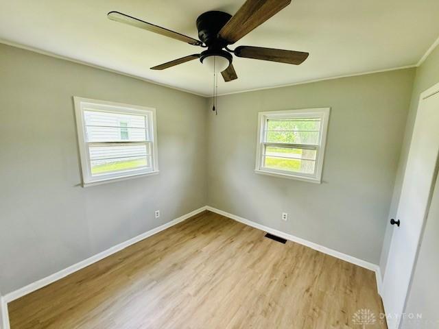 135 B St, Wilmington, OH 45177 - empty room with light wood finished floors and a ceiling fan