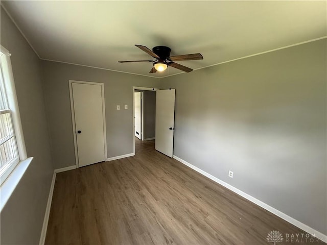 135 B St, Wilmington, OH 45177 - unfurnished bedroom with wood finished floors and a ceiling fan