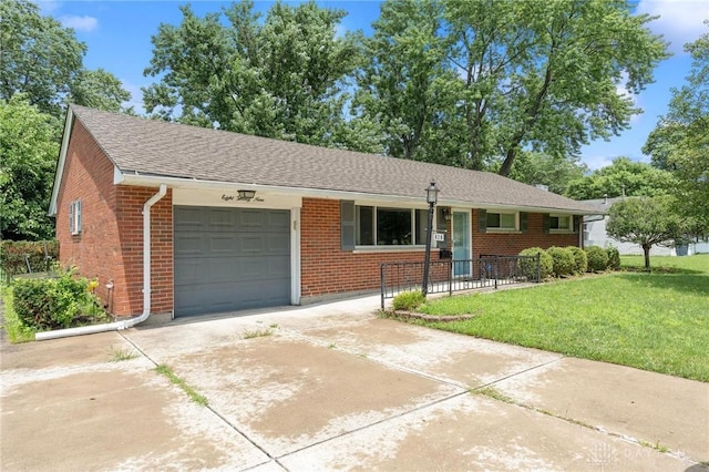 829 E Stroop Rd, Kettering, OH 45429 - ranch-style house with a garage, a front yard, brick siding, and concrete driveway