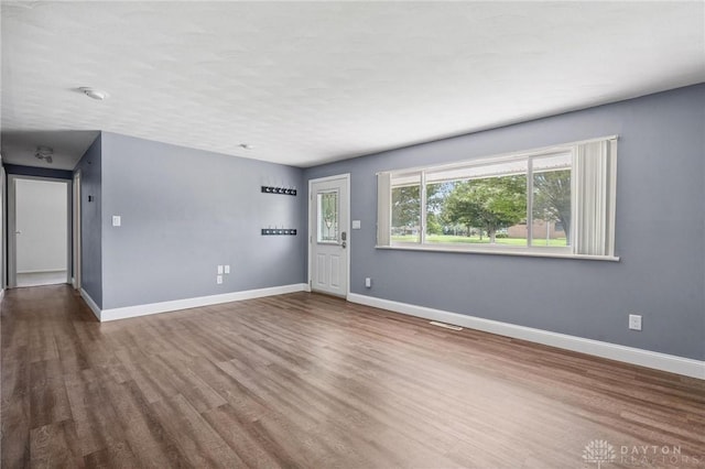 829 E Stroop Rd, Kettering, OH 45429 - unfurnished living room with wood finished floors and baseboards