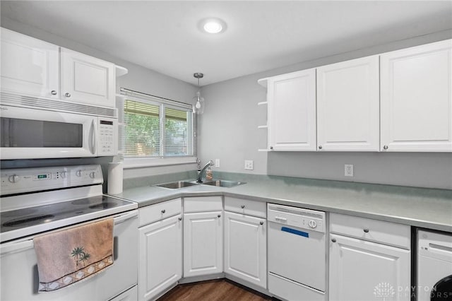 829 E Stroop Rd, Kettering, OH 45429 - kitchen featuring white appliances, washer / dryer, white cabinetry, light countertops, and dark wood finished floors