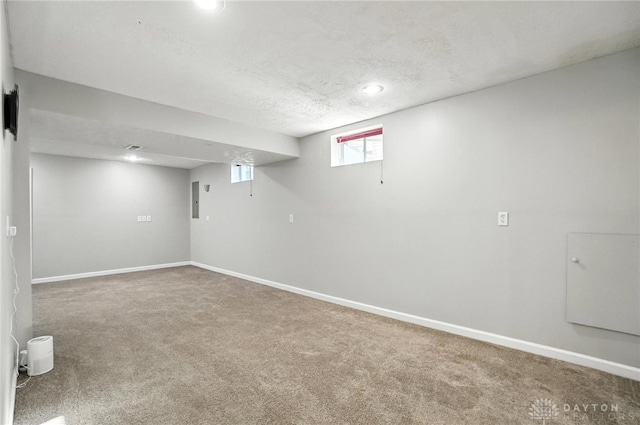 3492 King Edward Way, Beavercreek, OH 45431 - basement featuring carpet floors, a textured ceiling, electric panel, and recessed lighting