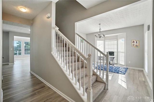 3492 King Edward Way, Beavercreek, OH 45431 - stairway with wood finished floors and a chandelier
