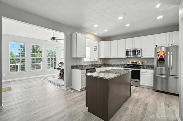 3492 King Edward Way, Beavercreek, OH 45431 - kitchen featuring stainless steel appliances, recessed lighting, dark stone countertops, light wood-type flooring, and a kitchen island