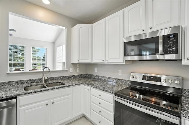 3492 King Edward Way, Beavercreek, OH 45431 - kitchen with appliances with stainless steel finishes, white cabinets, lofted ceiling, and dark stone counters