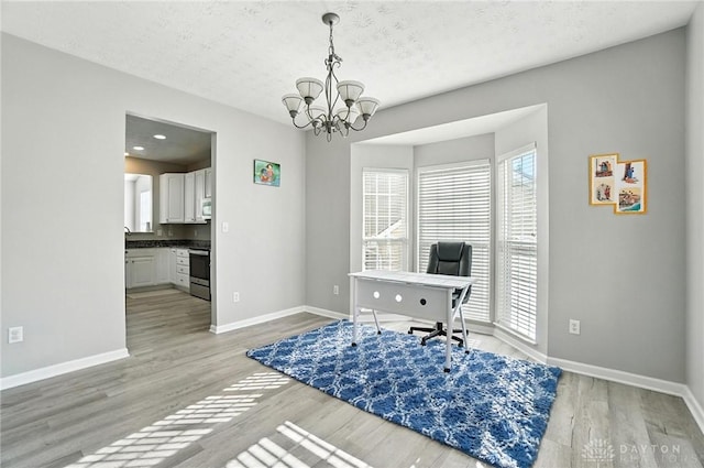 3492 King Edward Way, Beavercreek, OH 45431 - office with a chandelier, light wood finished floors, and a textured ceiling