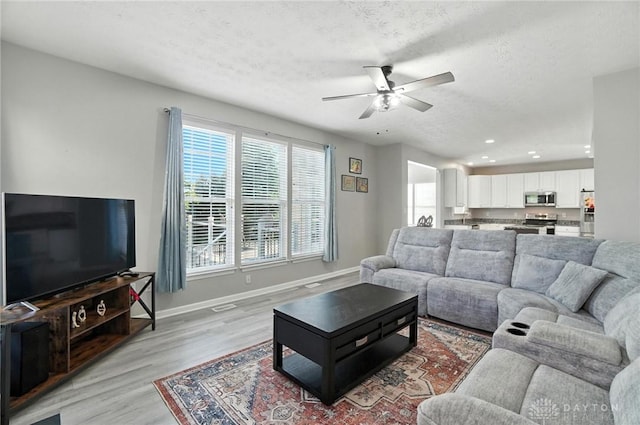 3492 King Edward Way, Beavercreek, OH 45431 - living area featuring light wood-type flooring, a ceiling fan, a textured ceiling, and recessed lighting