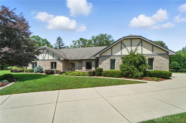 3820 Shagbark Ln, Beavercreek, OH 45440 - tudor house with a front lawn, brick siding, and stucco siding