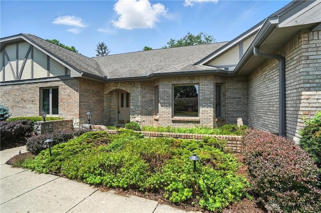 3820 Shagbark Ln, Beavercreek, OH 45440 - view of exterior entry featuring brick siding and a shingled roof