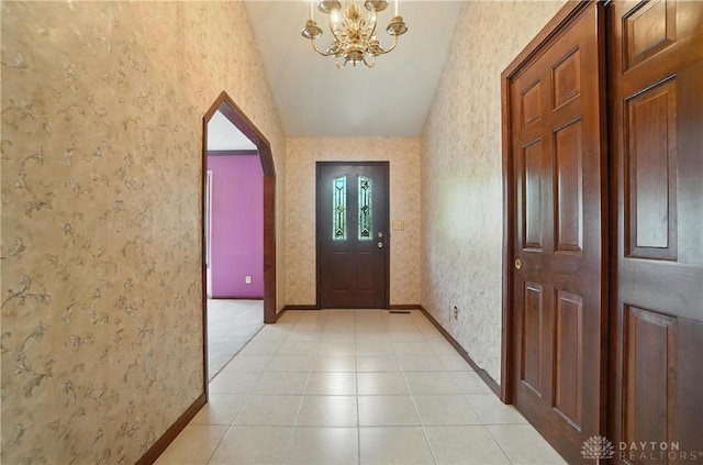 3820 Shagbark Ln, Beavercreek, OH 45440 - foyer entrance with wallpapered walls, vaulted ceiling, arched walkways, a chandelier, and light tile patterned floors