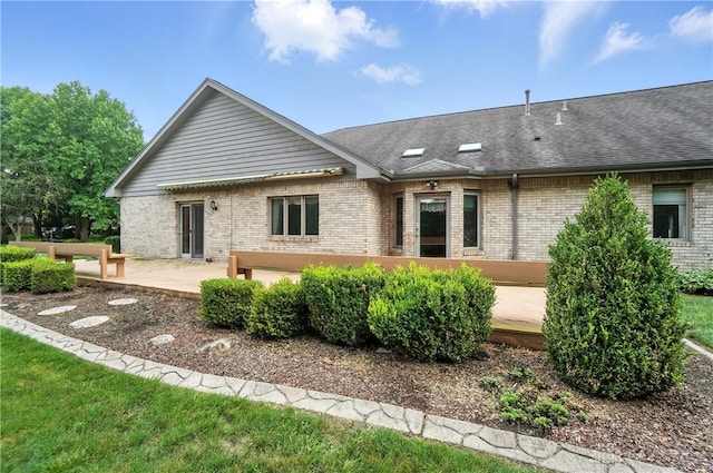 3820 Shagbark Ln, Beavercreek, OH 45440 - rear view of property featuring brick siding, roof with shingles, and a patio area