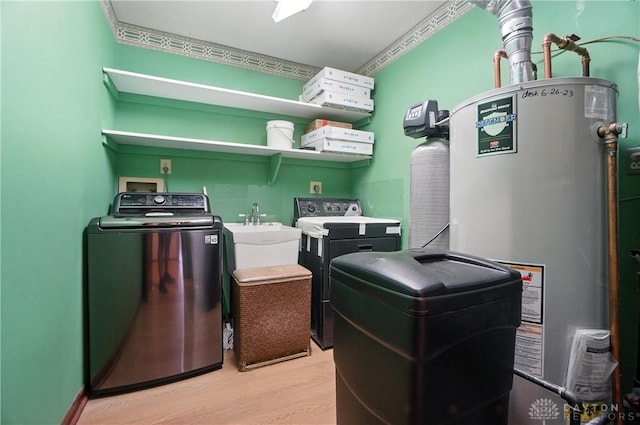 3820 Shagbark Ln, Beavercreek, OH 45440 - laundry room featuring washer and dryer, gas water heater, light wood-style flooring, and crown molding