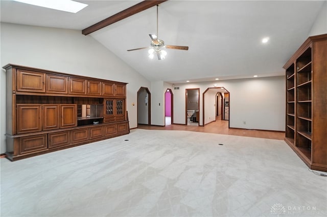 3820 Shagbark Ln, Beavercreek, OH 45440 - unfurnished living room with arched walkways, beamed ceiling, ceiling fan, recessed lighting, and high vaulted ceiling