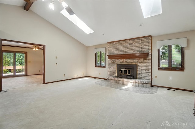 3820 Shagbark Ln, Beavercreek, OH 45440 - unfurnished living room with a skylight, high vaulted ceiling, a fireplace, light carpet, and beam ceiling