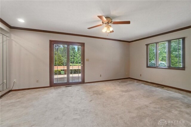 3820 Shagbark Ln, Beavercreek, OH 45440 - spare room with ornamental molding, plenty of natural light, a ceiling fan, and carpet floors