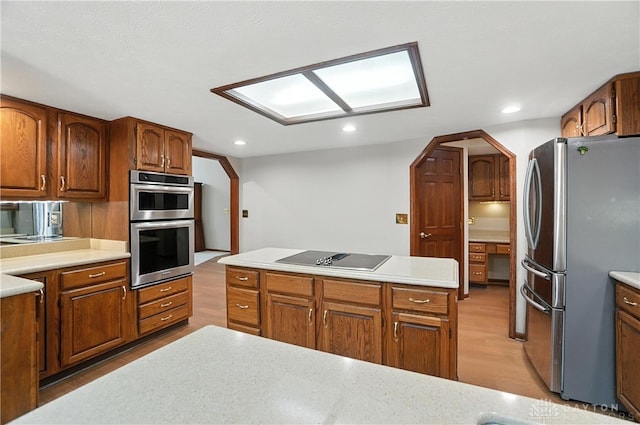 3820 Shagbark Ln, Beavercreek, OH 45440 - kitchen featuring appliances with stainless steel finishes, wood finished floors, light countertops, brown cabinets, and recessed lighting