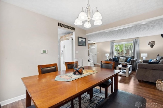 5431 Flicker Way, Dayton, OH 45424 - dining space with stairs, a chandelier, wood finished floors, and a textured ceiling