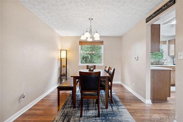 5431 Flicker Way, Dayton, OH 45424 - dining space with a chandelier, wood finished floors, and a textured ceiling