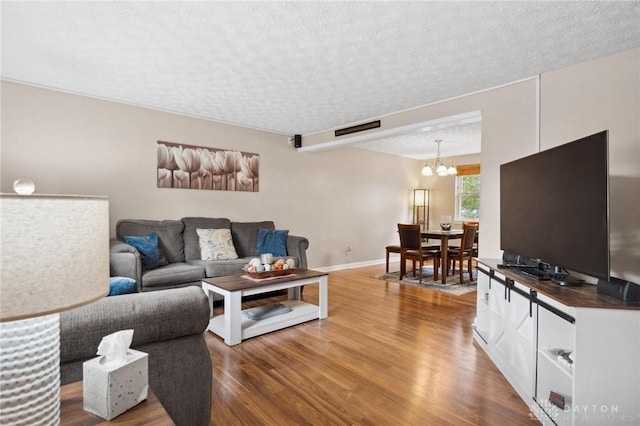 5431 Flicker Way, Dayton, OH 45424 - living area with wood finished floors, a chandelier, and a textured ceiling