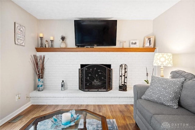 5431 Flicker Way, Dayton, OH 45424 - living area with wood finished floors and a brick fireplace