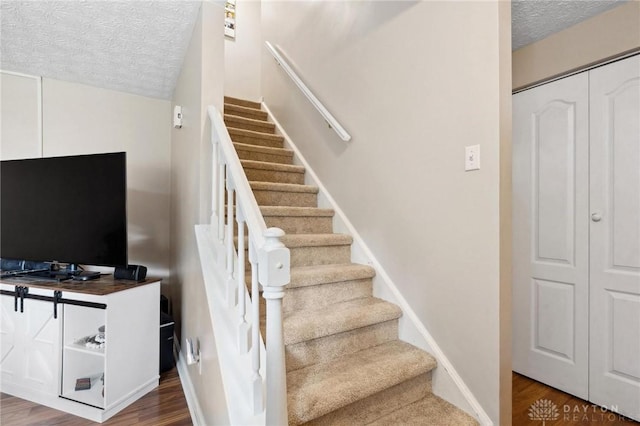 5431 Flicker Way, Dayton, OH 45424 - stairs featuring a textured ceiling and wood finished floors