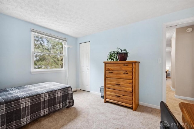5431 Flicker Way, Dayton, OH 45424 - bedroom featuring light colored carpet, a closet, and a textured ceiling