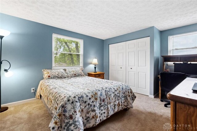 5431 Flicker Way, Dayton, OH 45424 - carpeted bedroom with multiple windows, a closet, a textured ceiling, and a desk