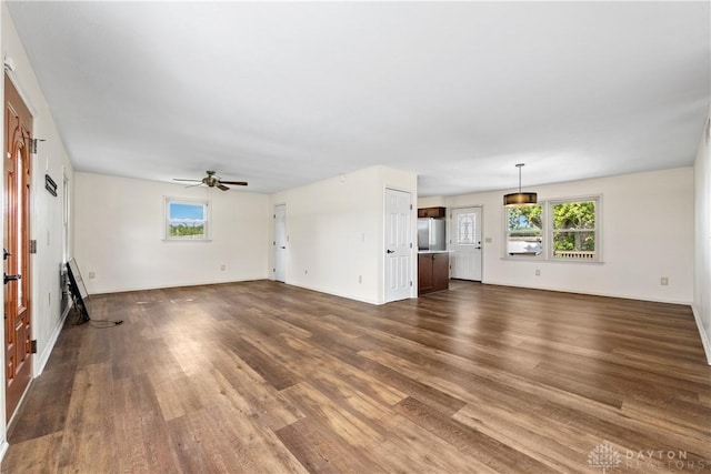 19551 US Highway 68, Fayetteville, OH 45118 - unfurnished living room featuring dark wood-type flooring, healthy amount of natural light, and a ceiling fan
